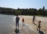 Wading in the ocean along the beach of the Strand Hotel